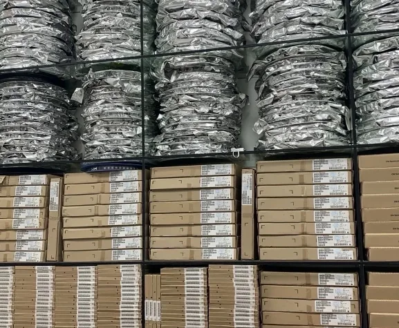 Protective bags and labelled component boxes arranged on shelves.