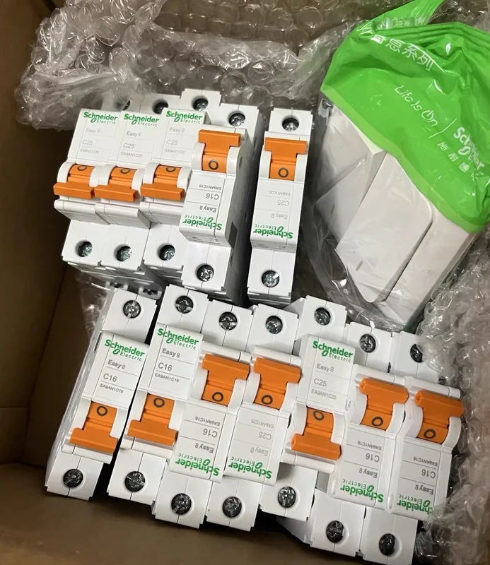 Circuit breakers with orange switches in protective packing.